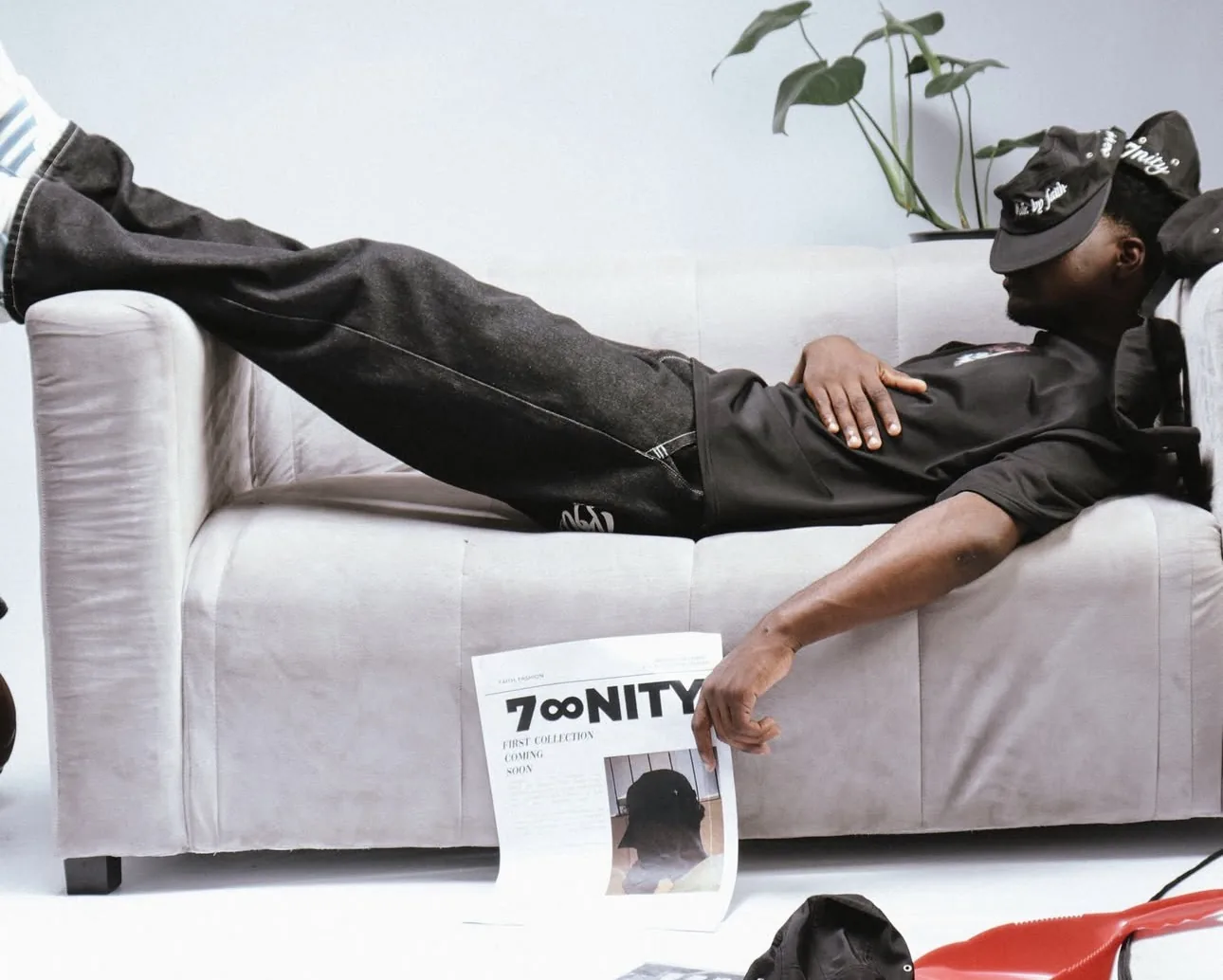 7nity Volume One campaign — model reading the first collection newspaper